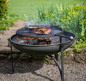 Plain Jane Firepit with BBQ rack with cooking food